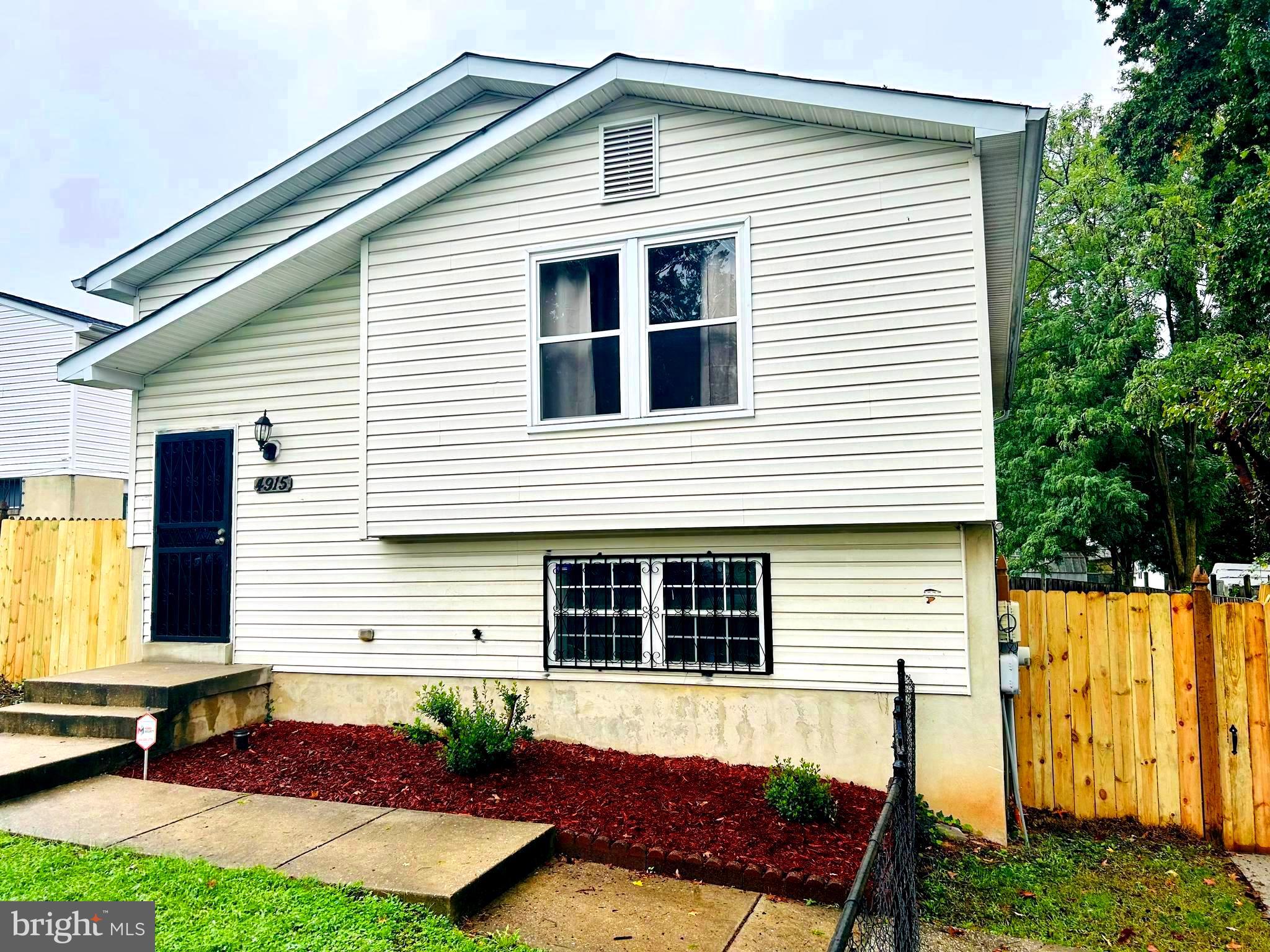 a front view of a house with a yard and outdoor seating