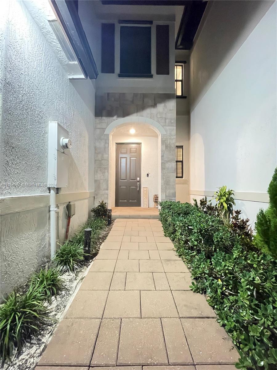 a view of a pathway both side of house