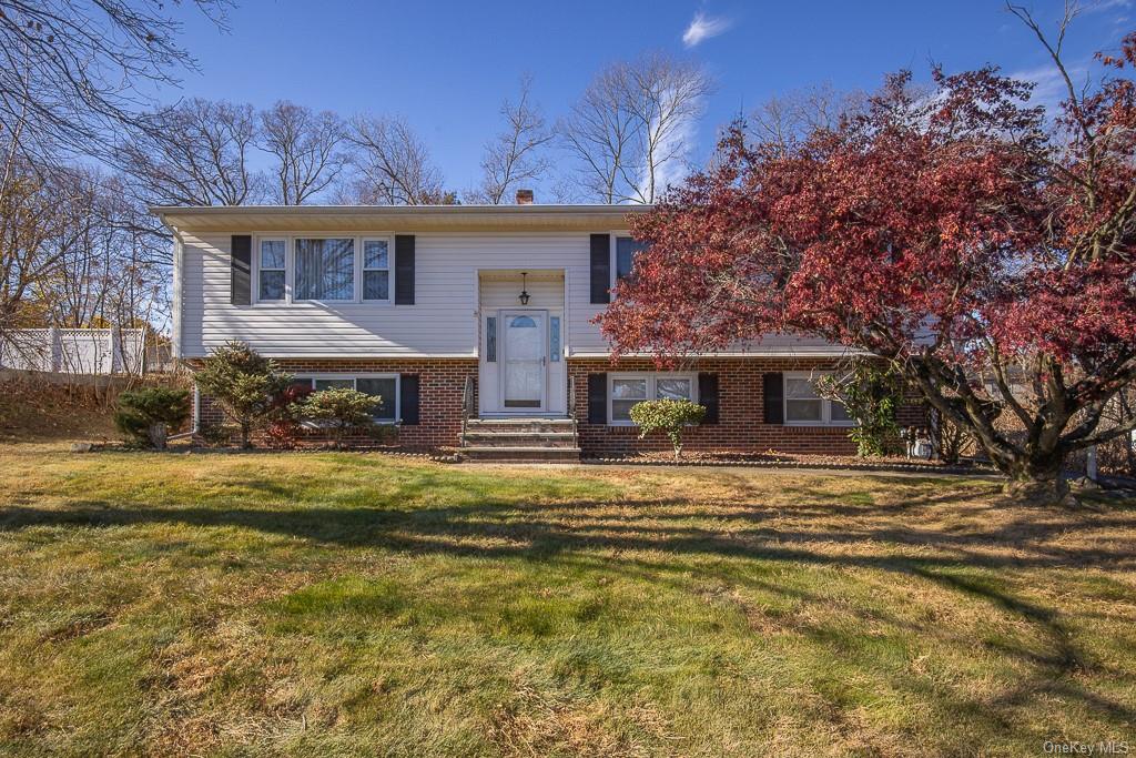 Bi-level home with a front yard