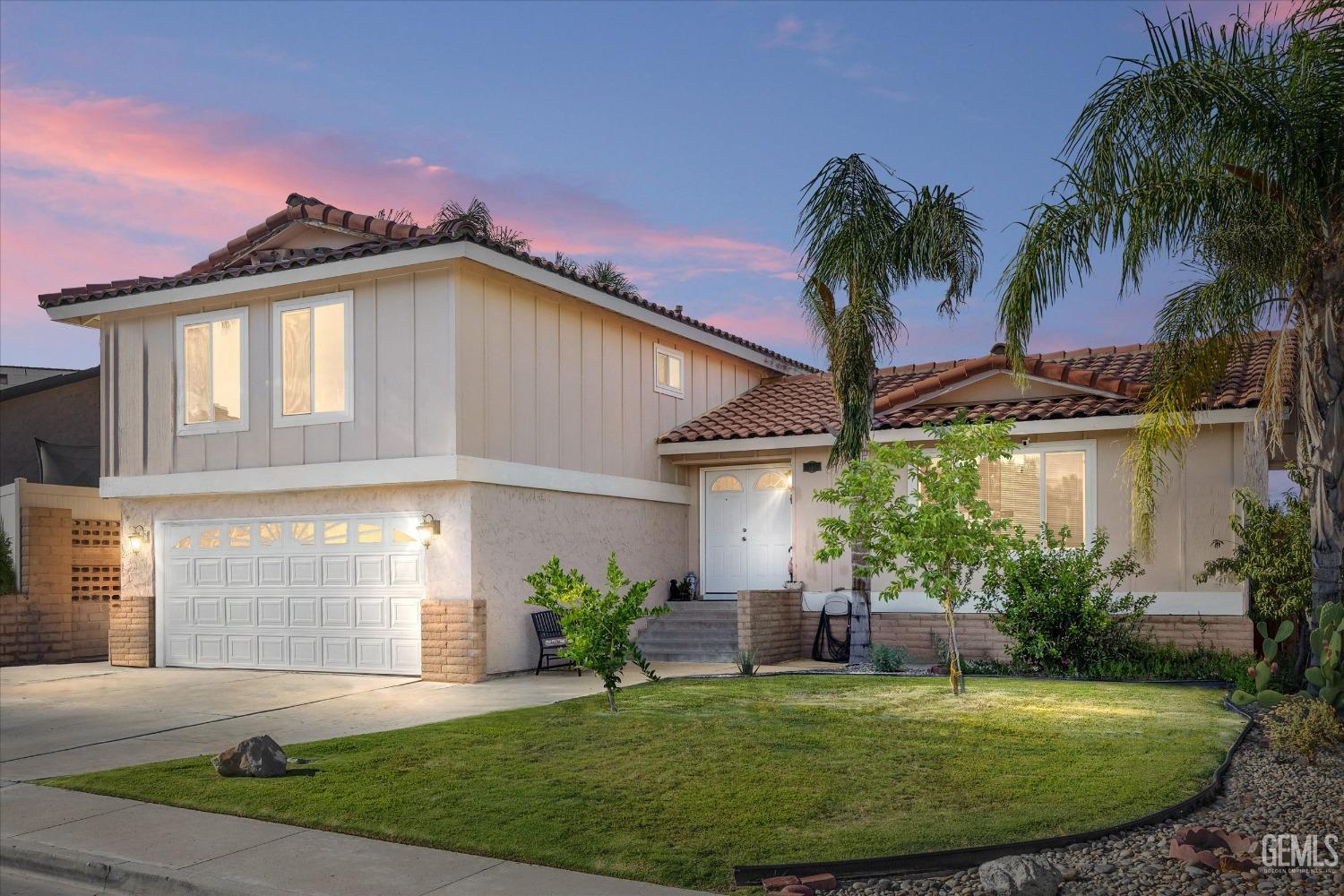 a front view of a house with a garden and patio