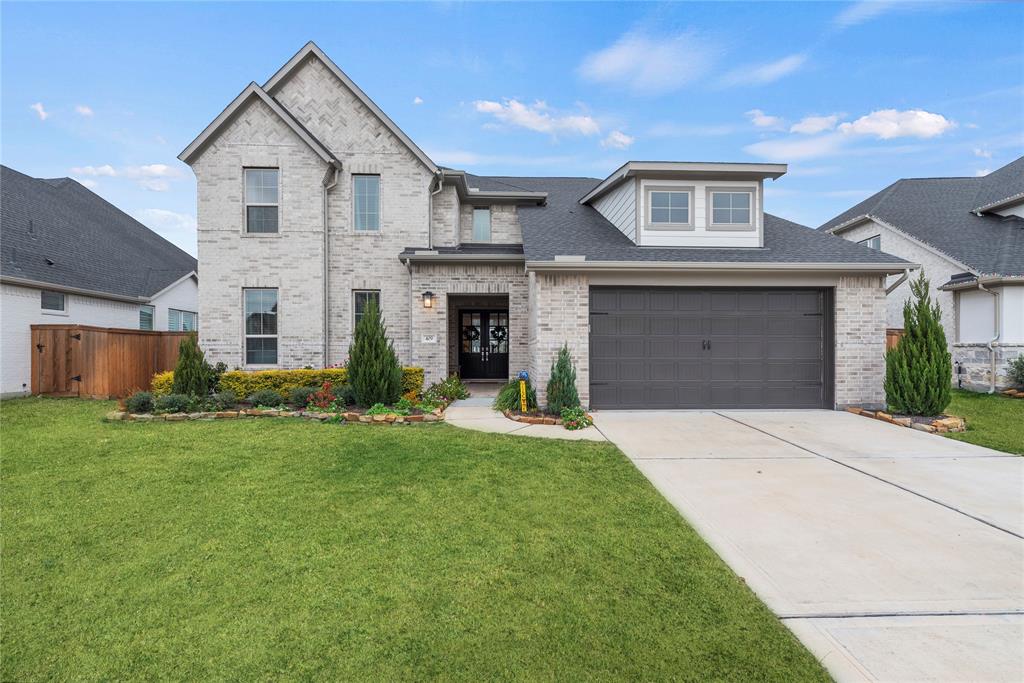 Welcome home to 409 Stratus View Court in the esteemed Lake House community in Katy!