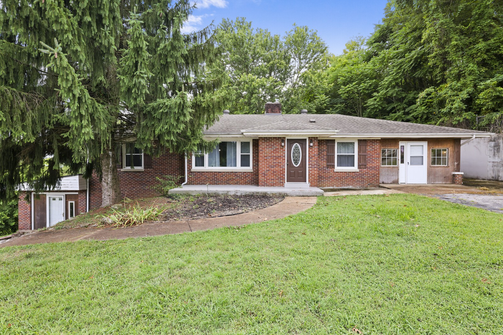 a front view of a house with a garden