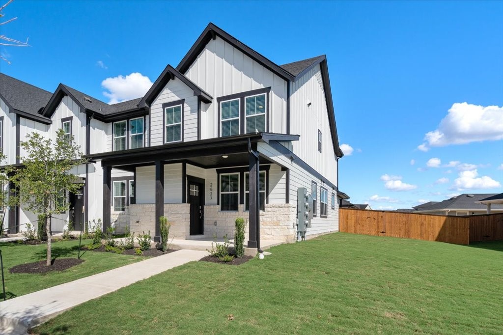 a view of a house with a yard and deck