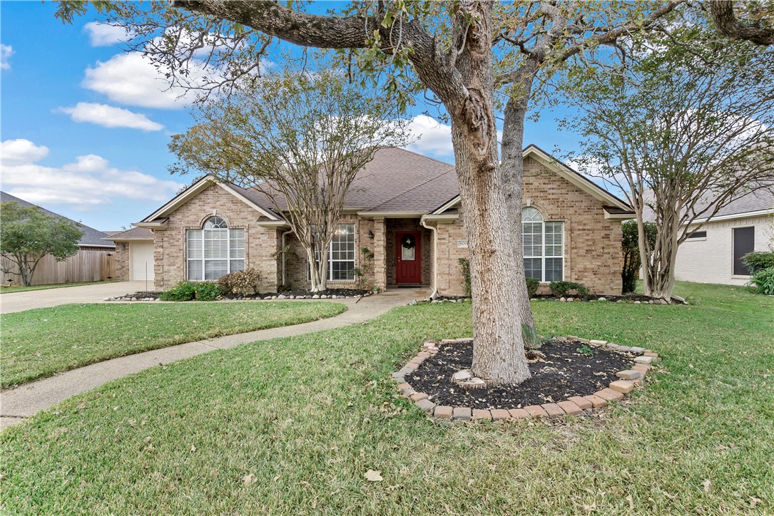 Ranch-style house with a front yard and a garage