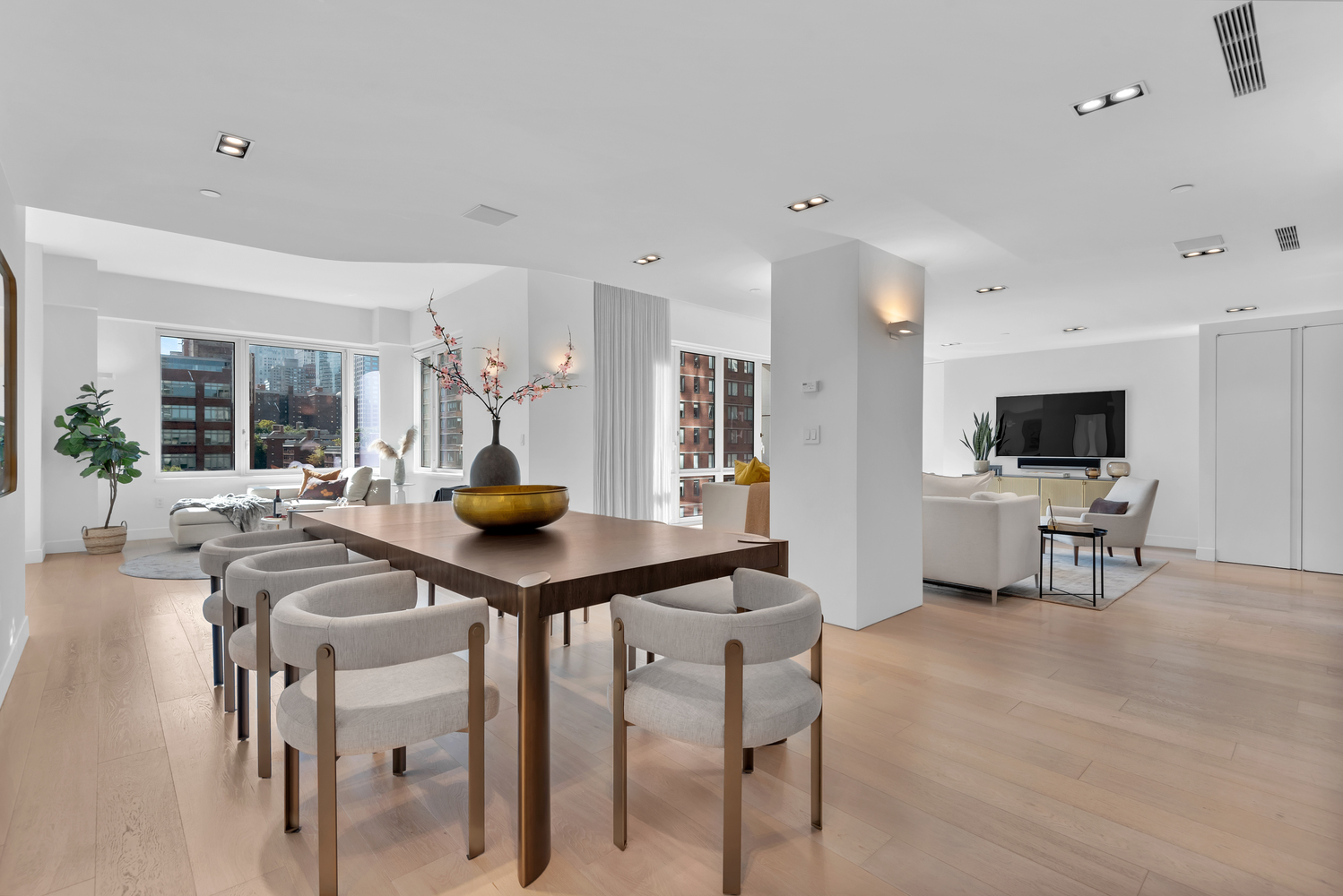 a living room with furniture and view of kitchen