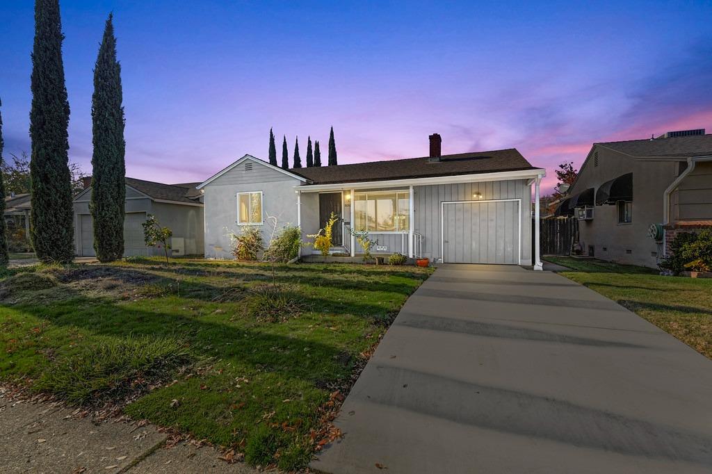 a front view of a house with a garden and yard