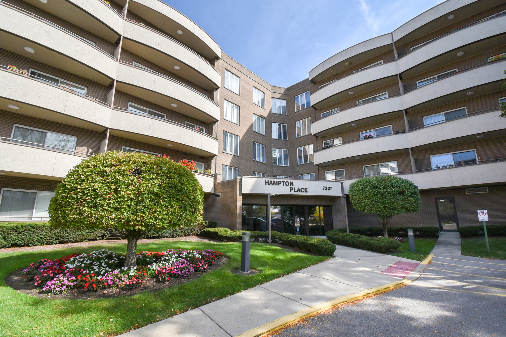 a front view of a building with a garden