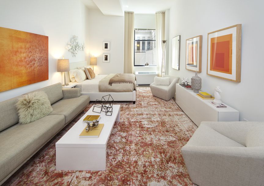 a living room with furniture and stairs