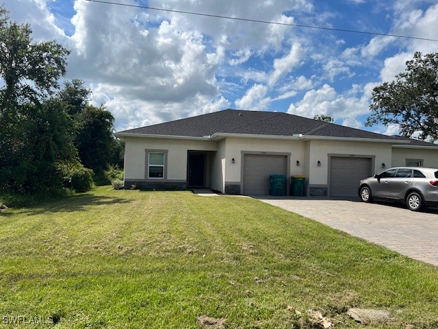 a front view of a house with garage and yard