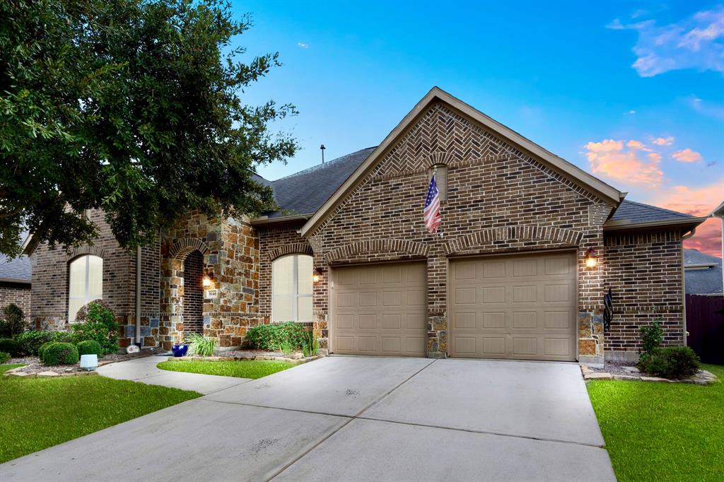 Darling Homes preferred single-story plan with a generous double garage, stone accents, and a well-maintained lawn.