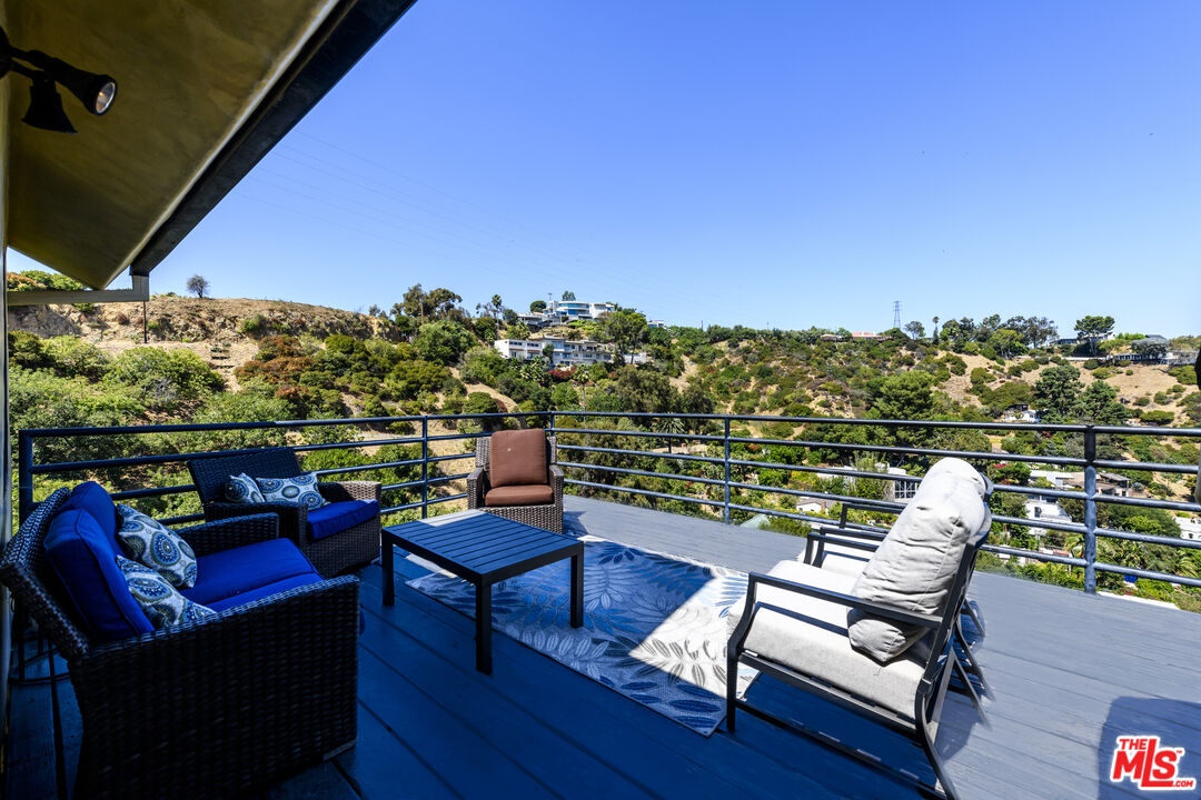 a view of a balcony with chairs