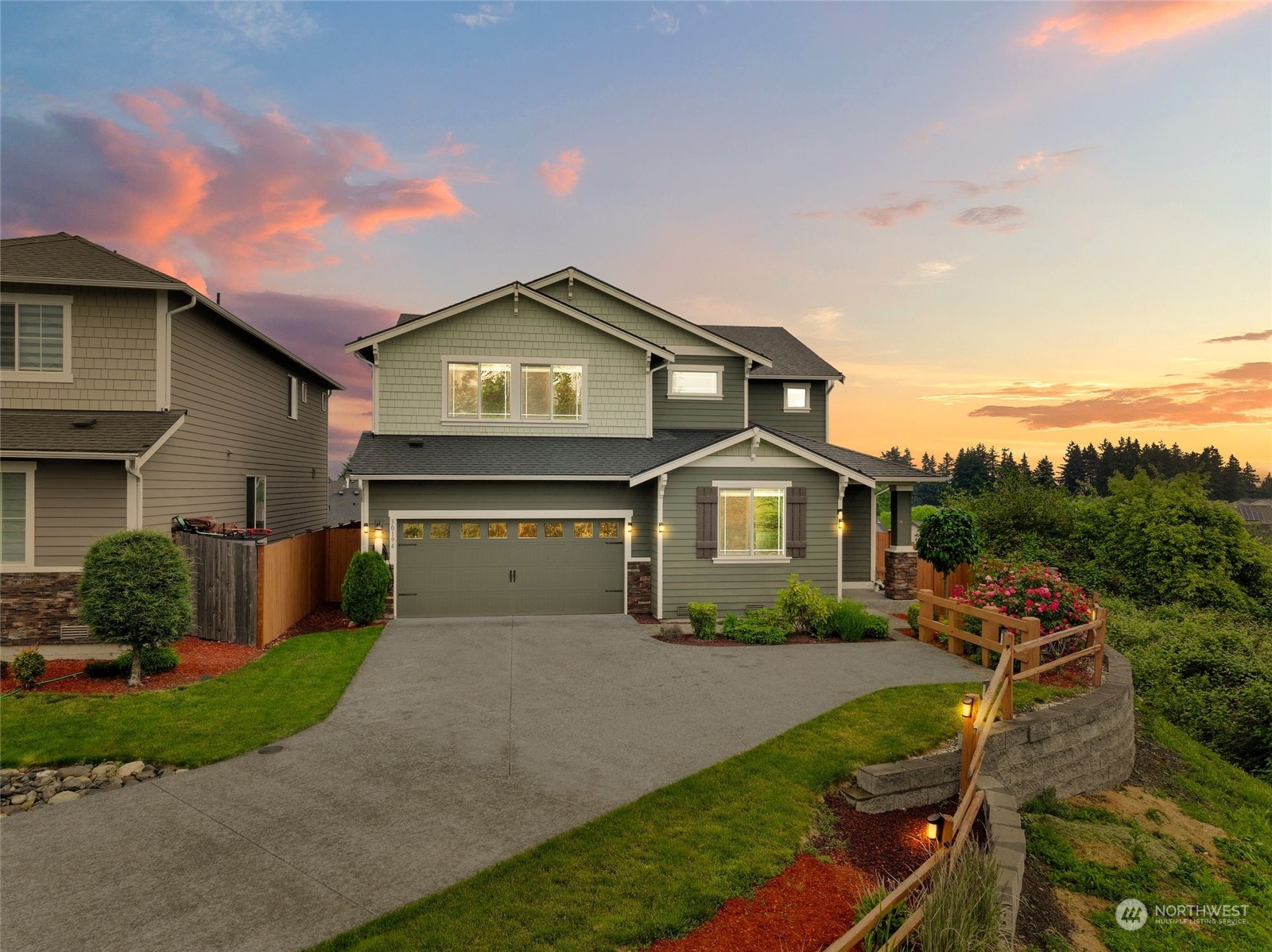 a front view of a house with a yard and garage