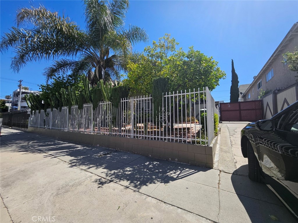 a view of a bench with wooden fence