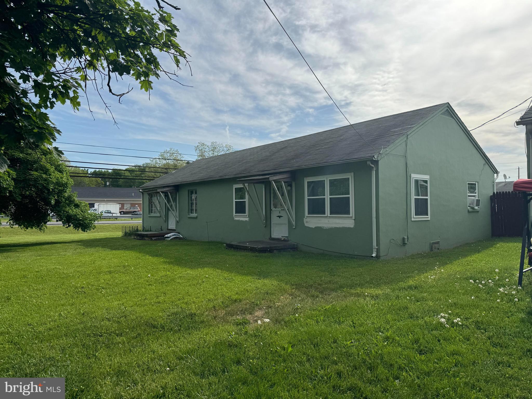 a view of a house with a backyard