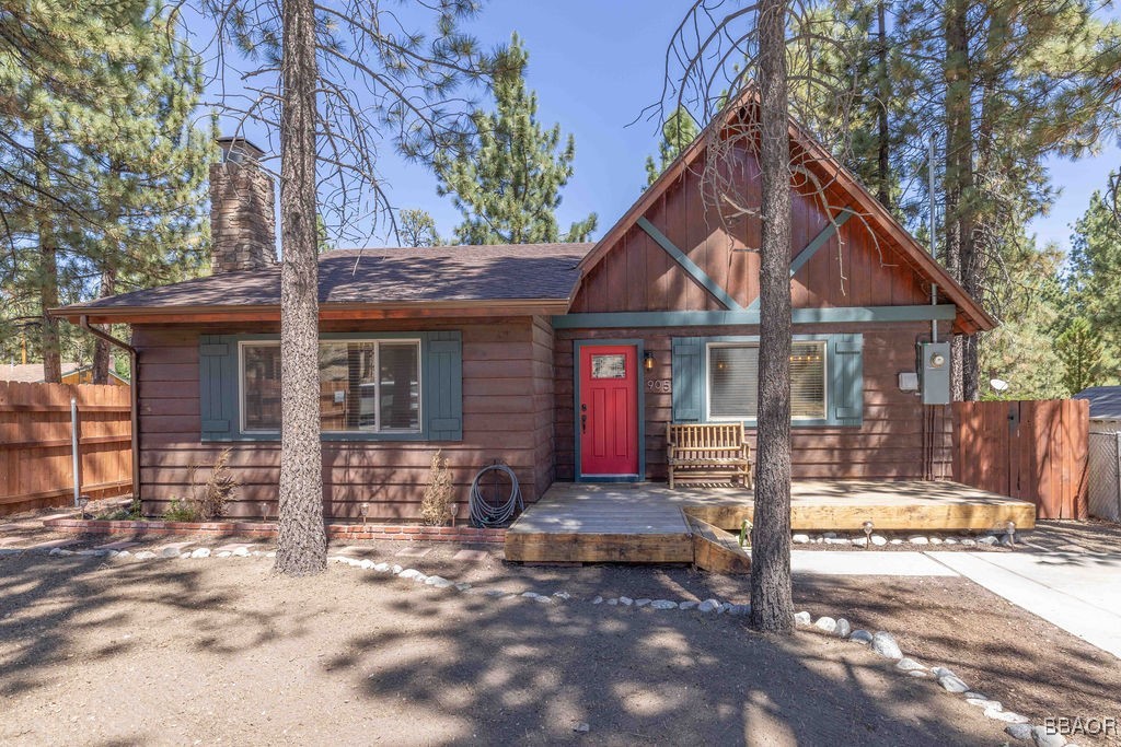 a front view of a house with a tree