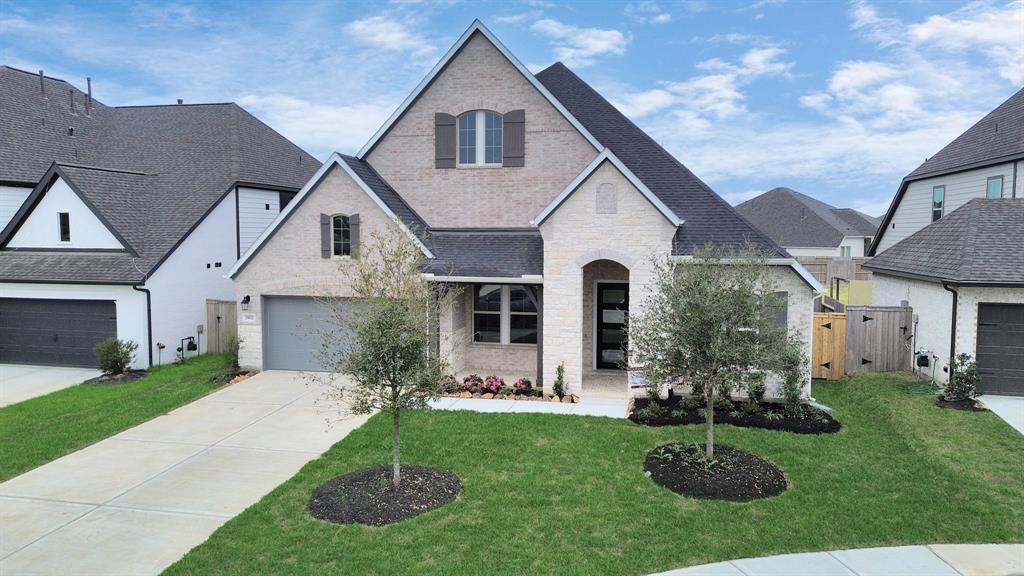 a front view of a house with a yard and outdoor seating