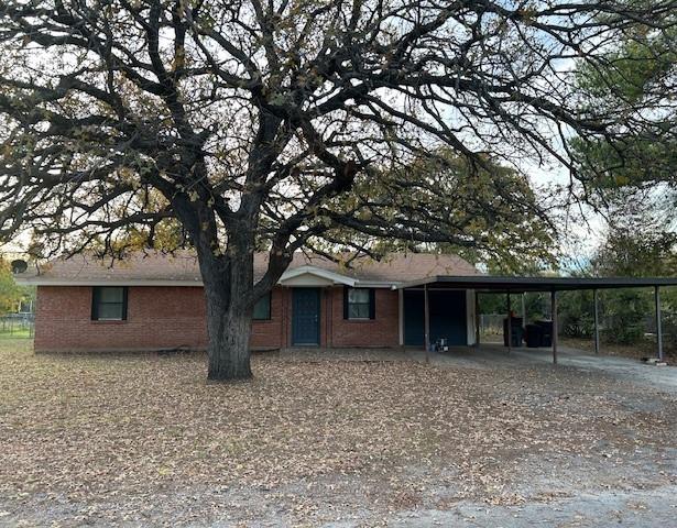 front view of a house with a tree