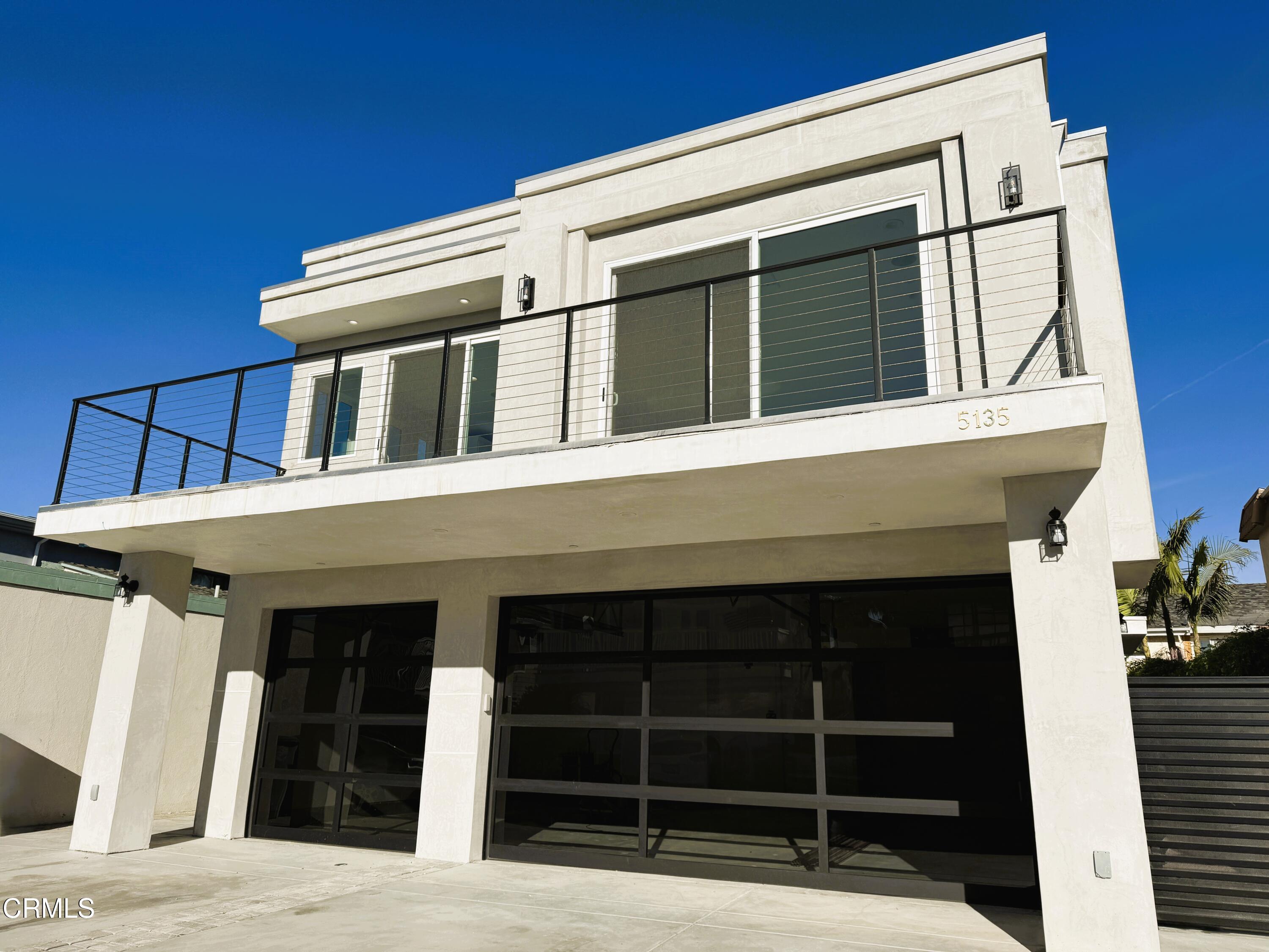 a view of a house with large windows