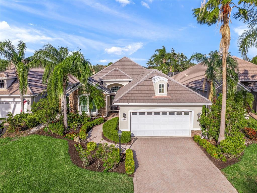 a front view of a house with a yard and garage