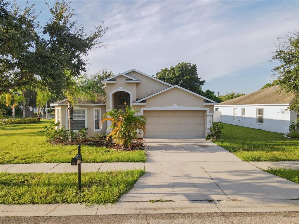 a front view of house with yard and green space