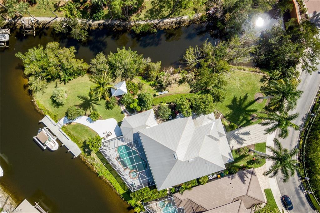 an aerial view of a house with a yard and lake view