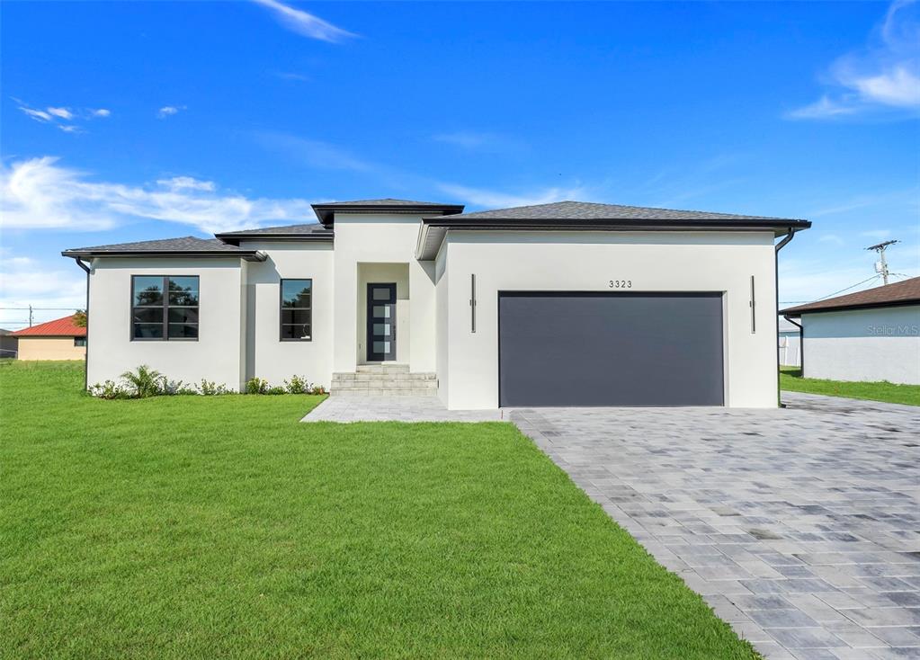 a front view of a house with a yard and garage