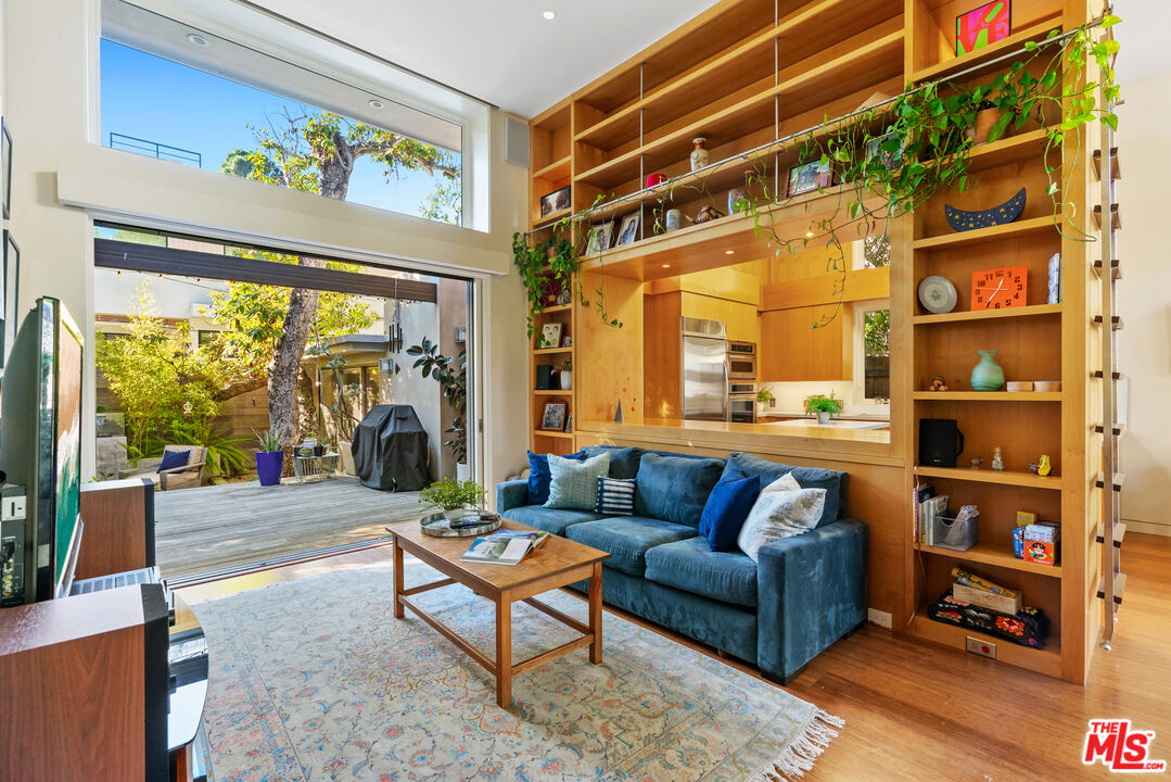 a living room with furniture a rug and a large window