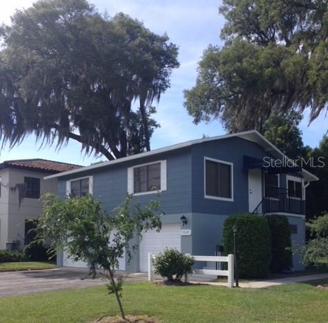 a house that has a tree in front of it