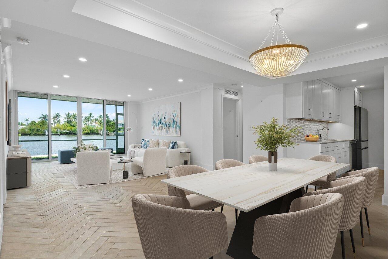 a view of a dining room with furniture wooden floor and chandelier