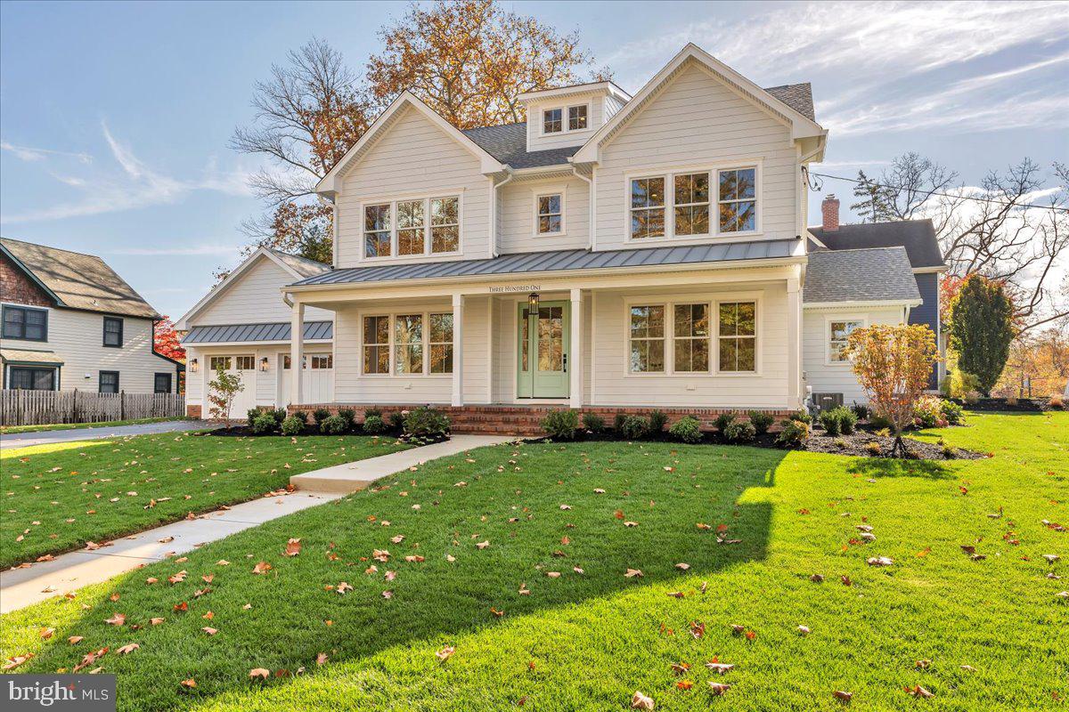 a front view of a house with a garden and trees