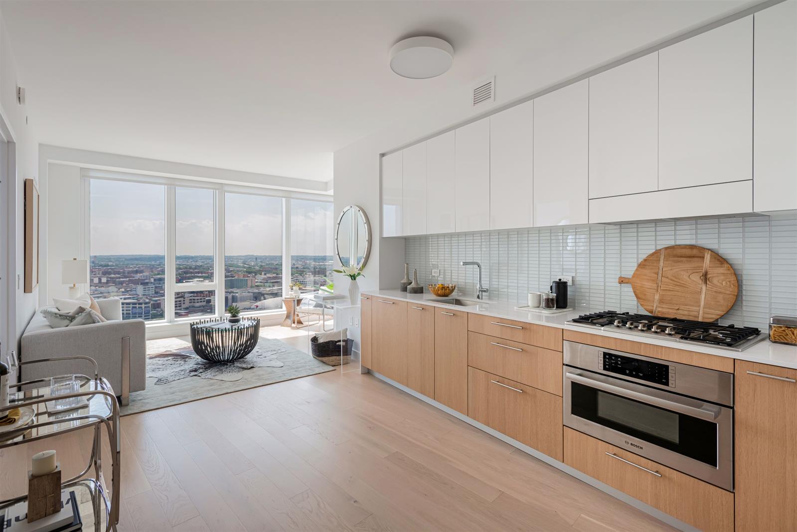 a kitchen with a stove a sink and white cabinets