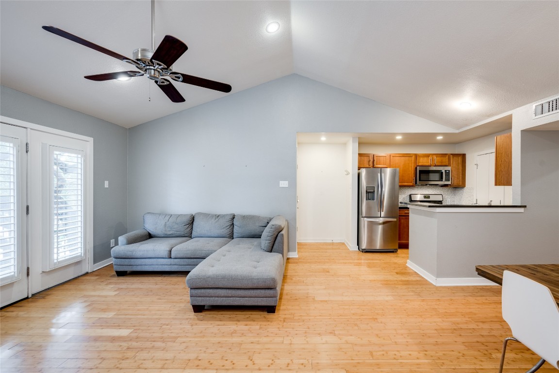 a living room with furniture and kitchen view