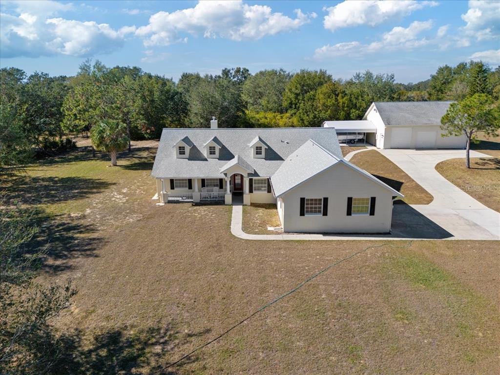 an aerial view of a house with a yard