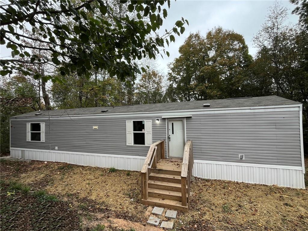 a view of a house with a backyard