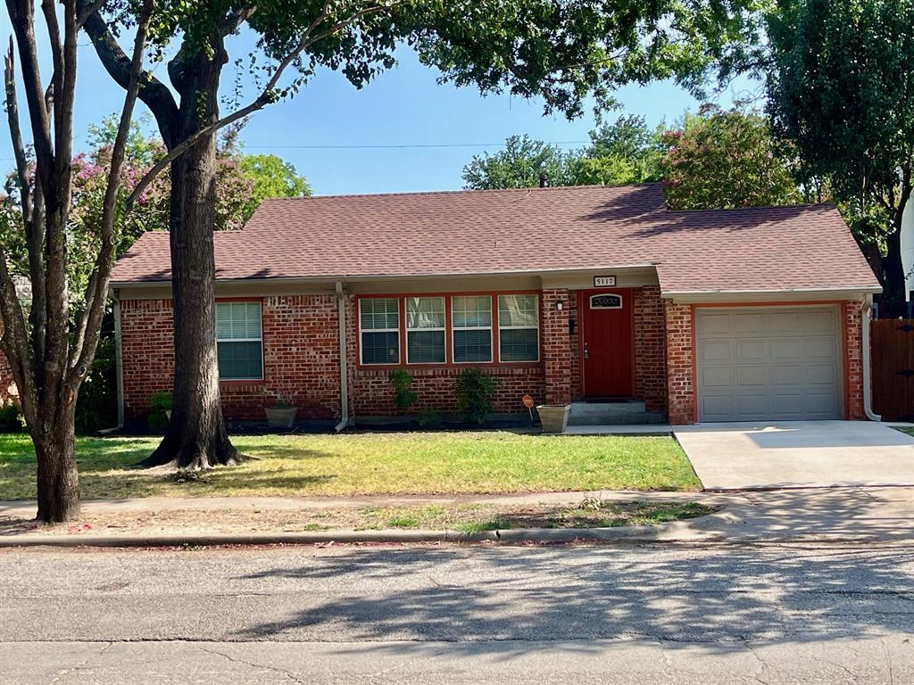 a house that has a tree in front of it