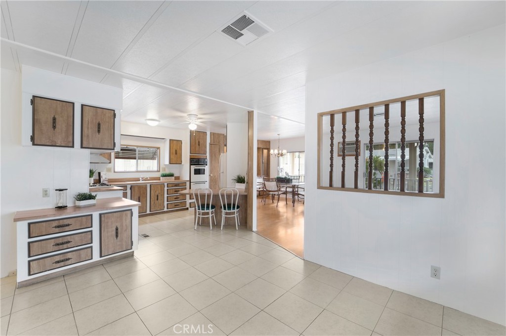 a open kitchen with cabinets and chairs