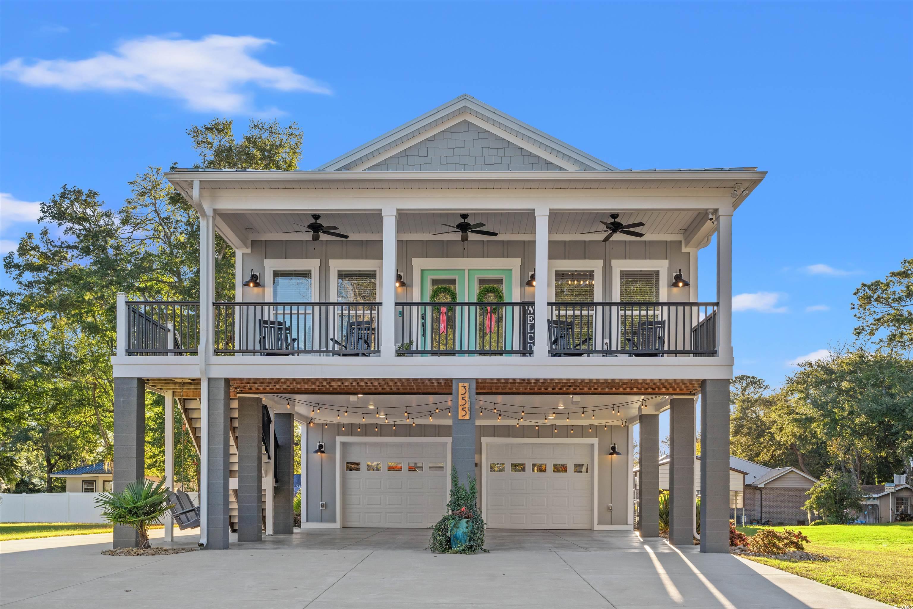 View of front of house with a carport and a garage