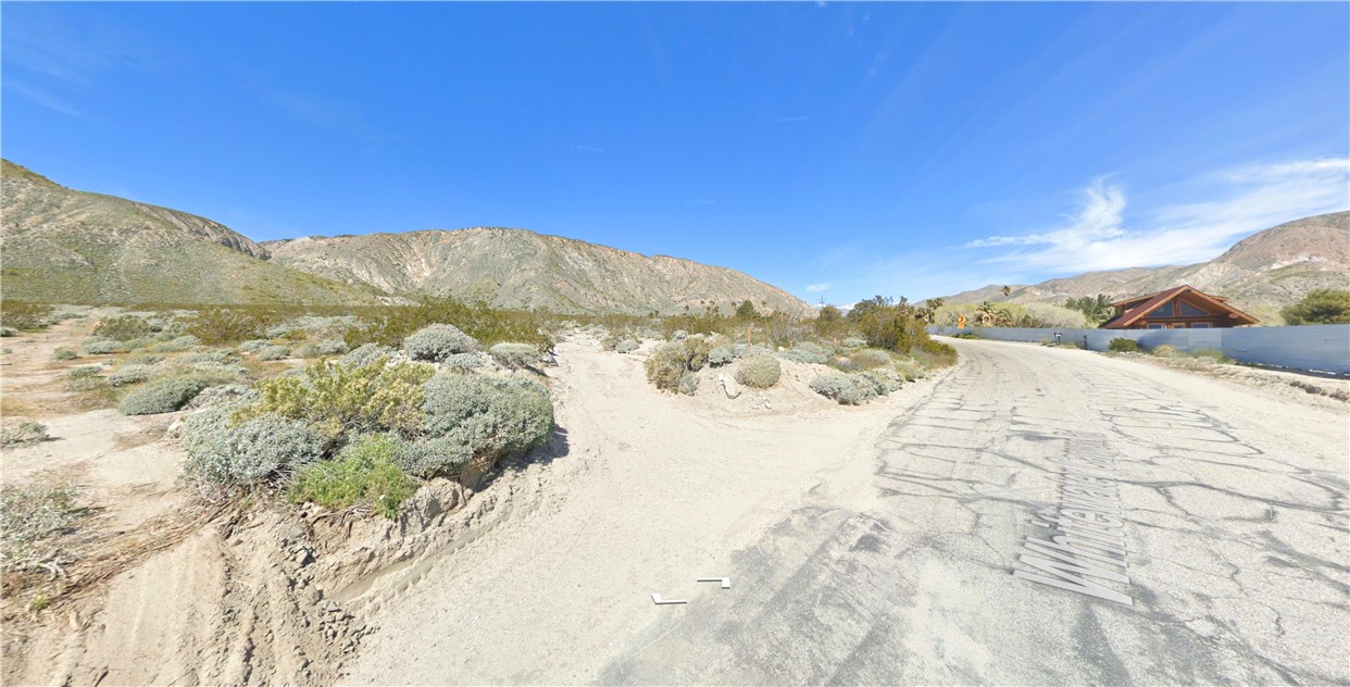 a view of a dry yard with a mountain