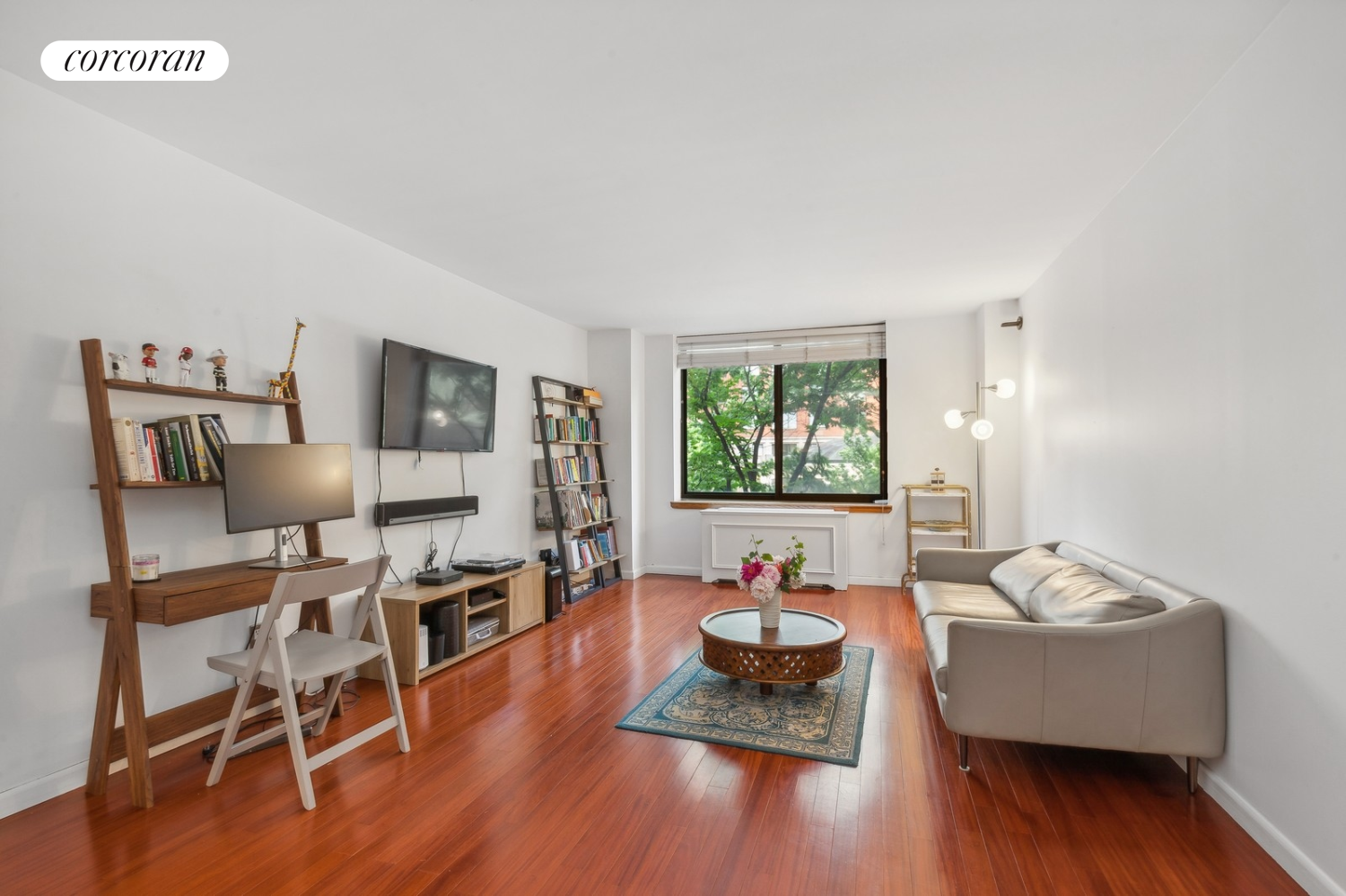 a living room with furniture and a wooden floor