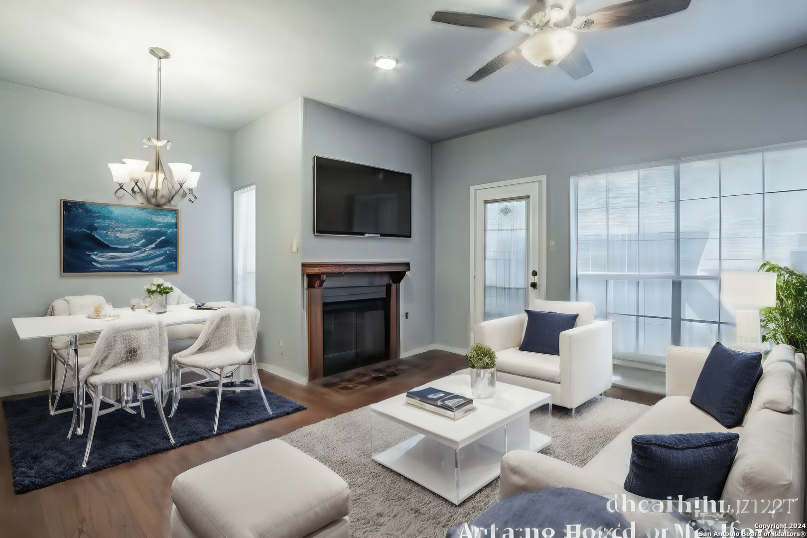 a living room with furniture a chandelier and a flat screen tv