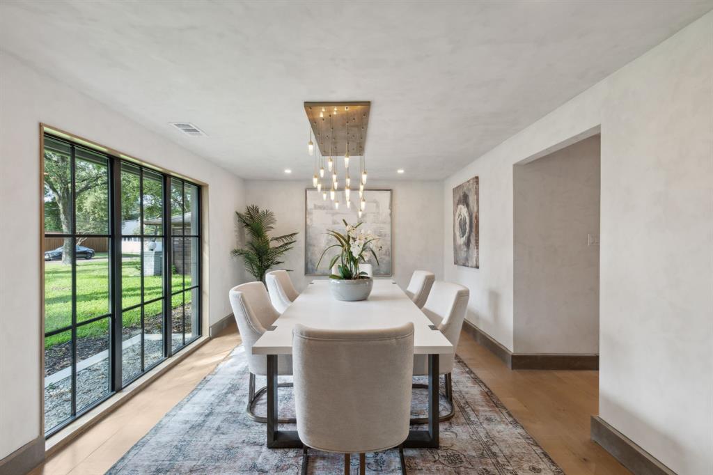 a dining room with furniture window and wooden floor