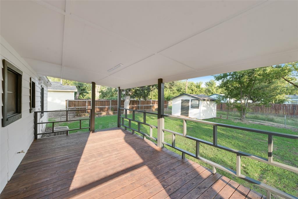 a view of a deck with a big yard next to a yard