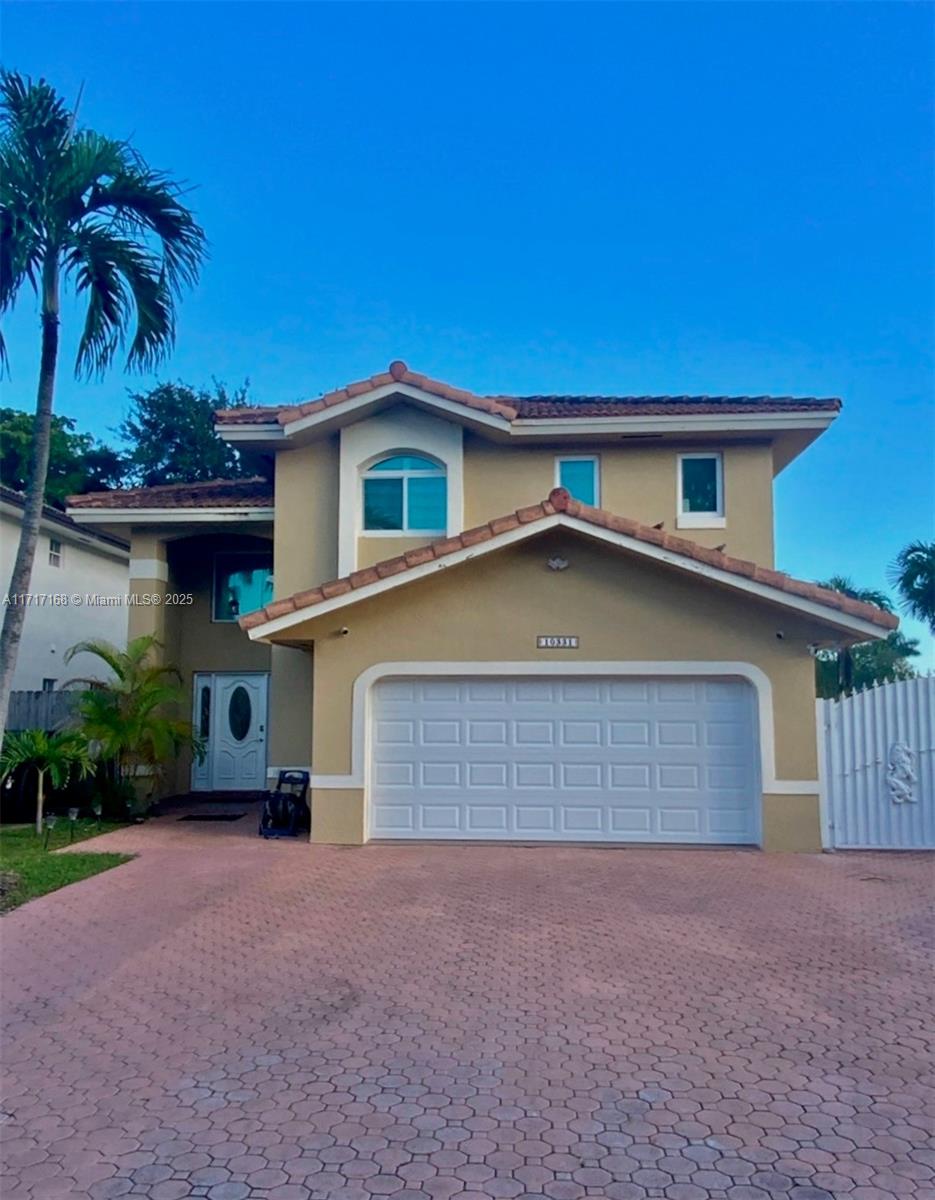 a front view of a house with a yard and garage