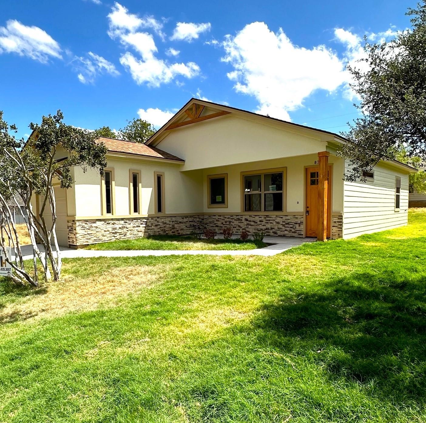 a front view of house with yard and green space