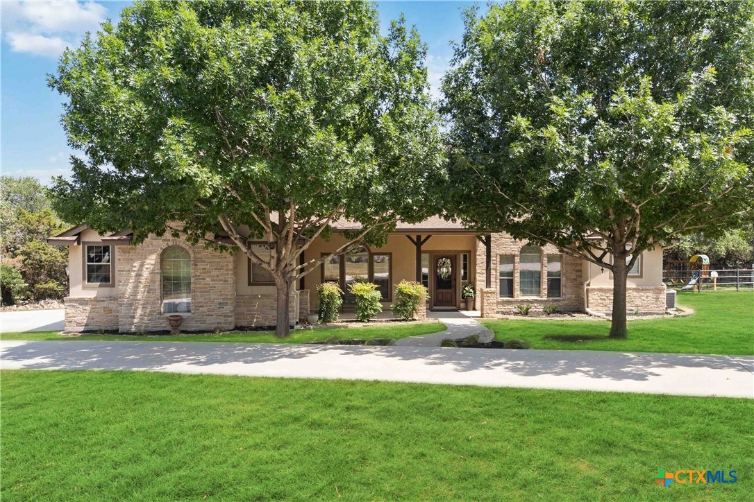 a front view of house with yard and green space