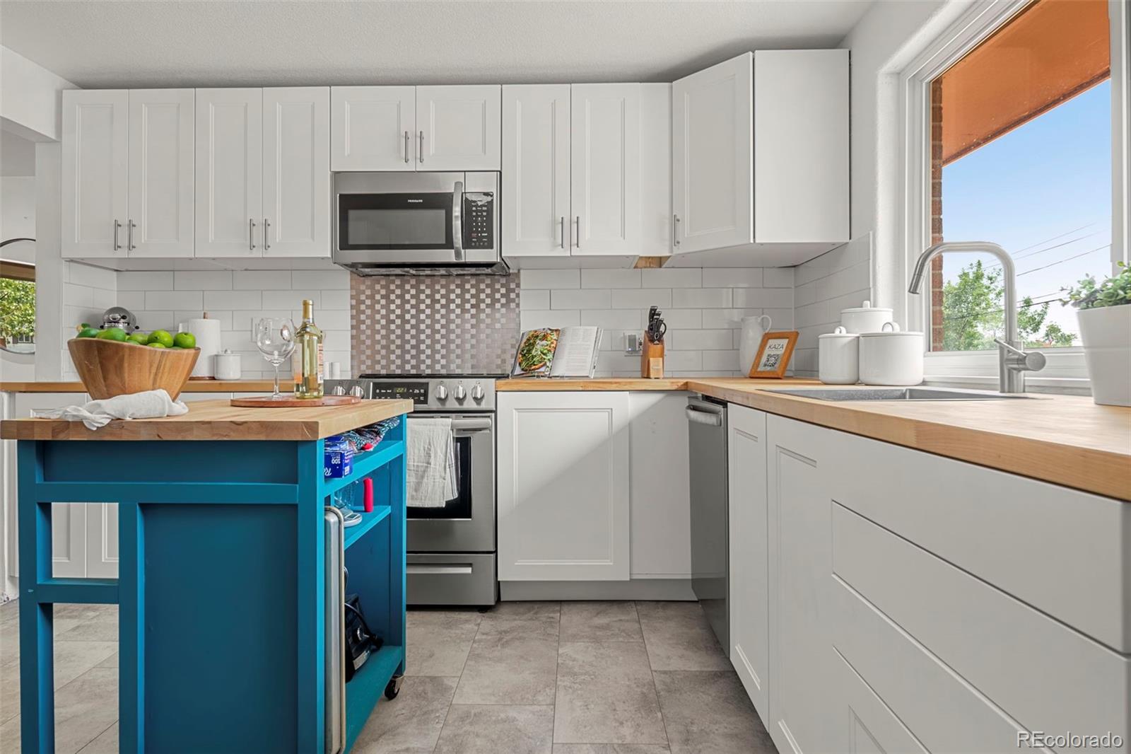 a kitchen with stainless steel appliances granite countertop a sink and a microwave