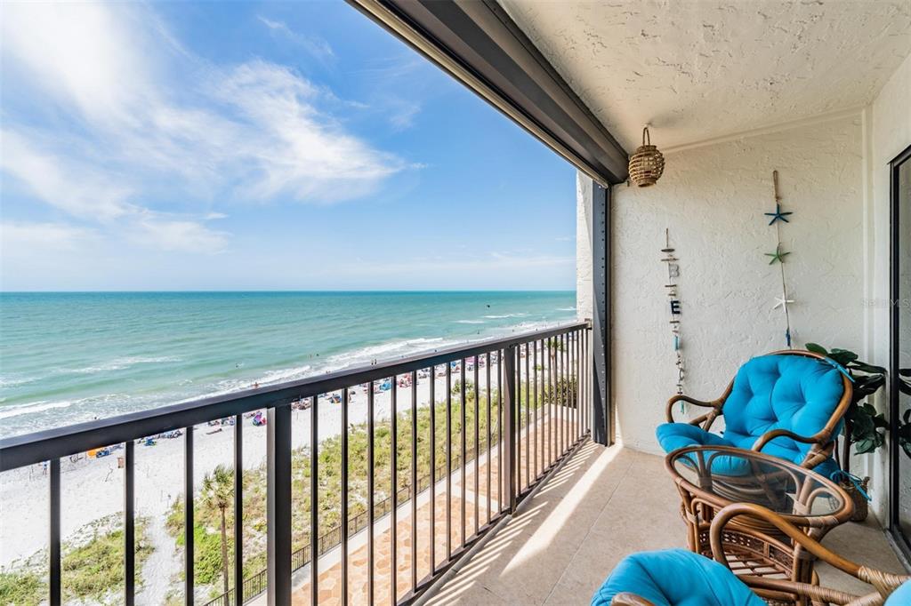 a view of a balcony with chairs