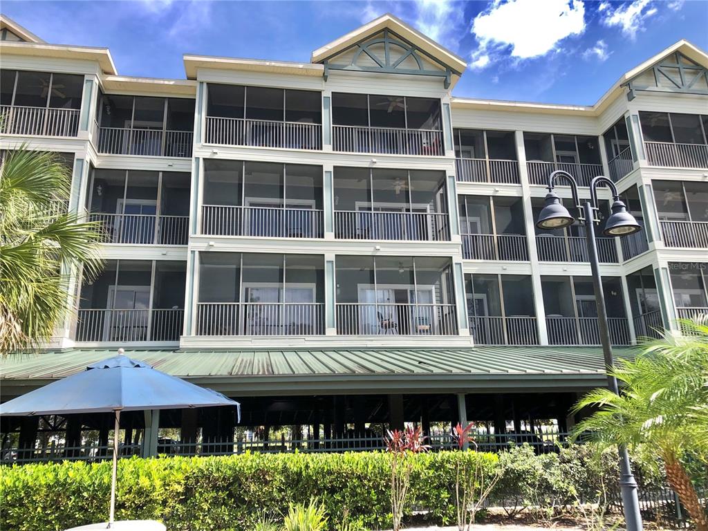 a front view of a building with a garden