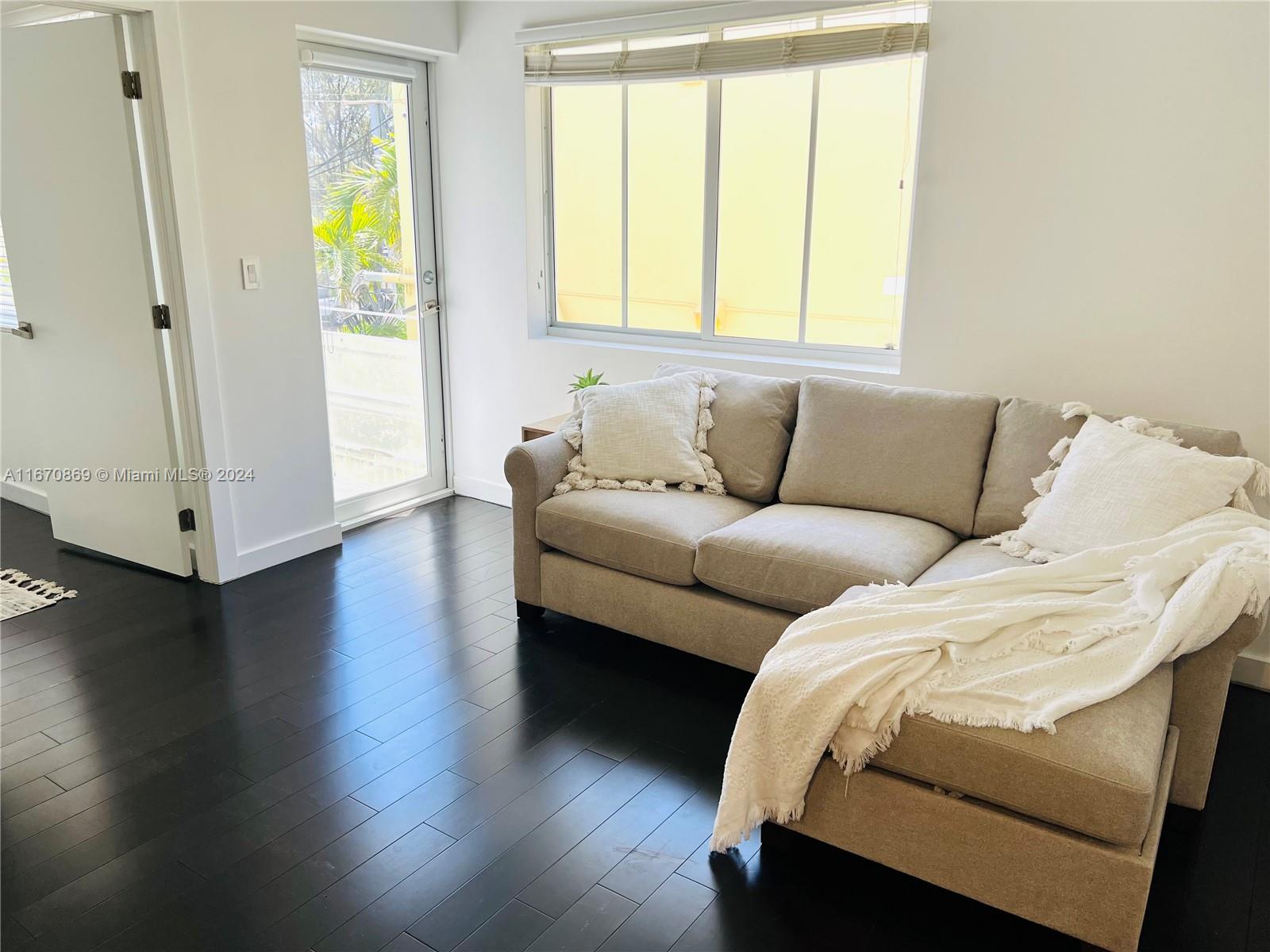 a living room with a couch and a window