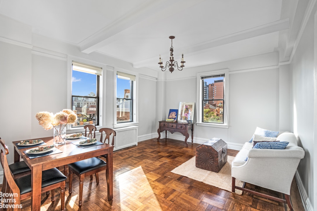 a living room with furniture and a dining table